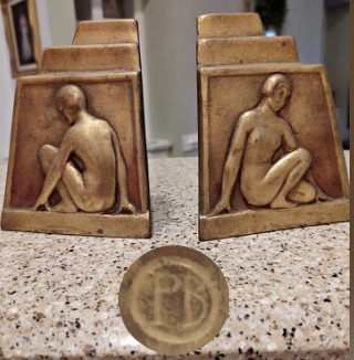 Bronze bookends marked "PB in a circle